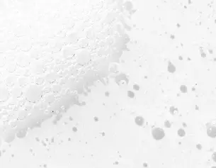 Close-up of white bubbles on a light background, creating a textured, frothy appearance.