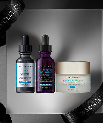 Three skincare products presented on a light gray platform, surrounded by a black ribbon with "SKINCEUTICALS" printed on it. The products include two dropper bottles and a cream jar.