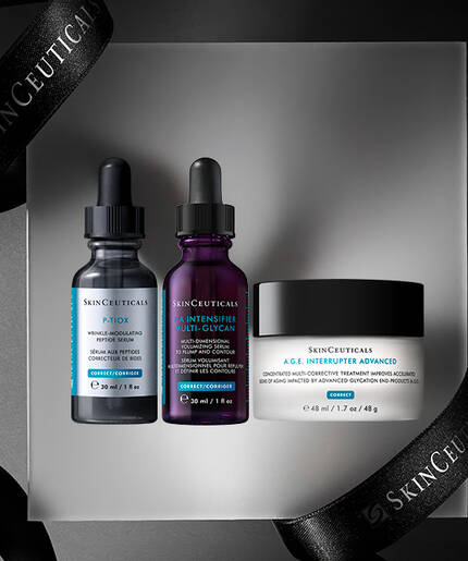 A minimalistic display featuring three skincare products from Skinceuticals: two dropper bottles and a cream jar, arranged on a reflective surface with black ribbons in the background.
