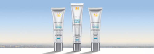 Three tubes of skincare products are lined up against a serene blue gradient background, suggesting a calm and refreshing atmosphere.