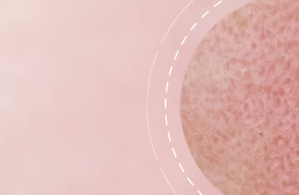 A close-up of a textured surface on a light pink background, with curved white lines accentuating the shape.
