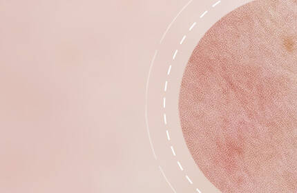 A soft, blurred background in muted pink tones with a circular pattern on the right, featuring a textured surface and dotted outline.